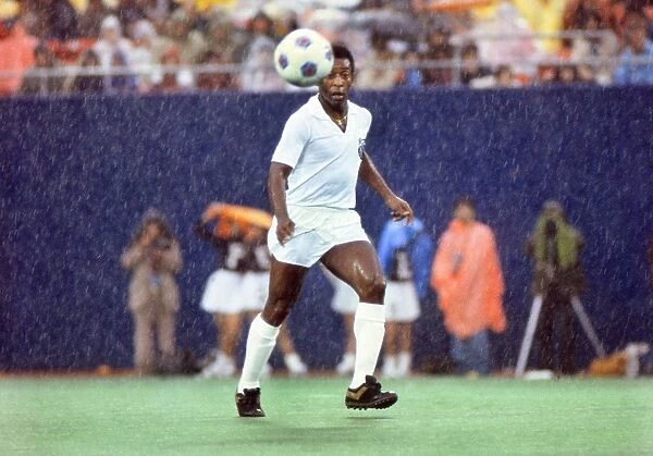 Pele playing for Santos in the rain during his farewell game in 1977