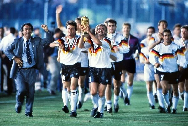 Rudi Voller celebrates with the World Cup trophy in 1990