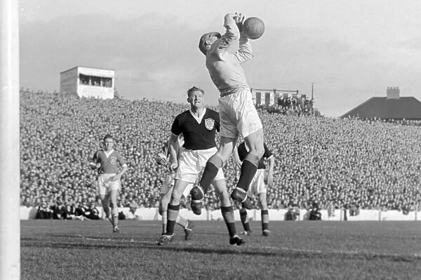 Scotland keeper Tommy Younger catches a high ball with George Young looking on in 1956