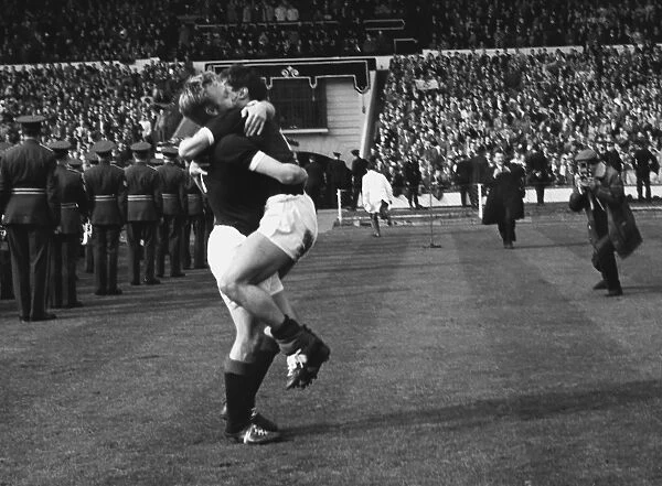 Scotlands Davie Wilson hugs a teammate after victory at Wembley - 1962 / 3 British Home Championship