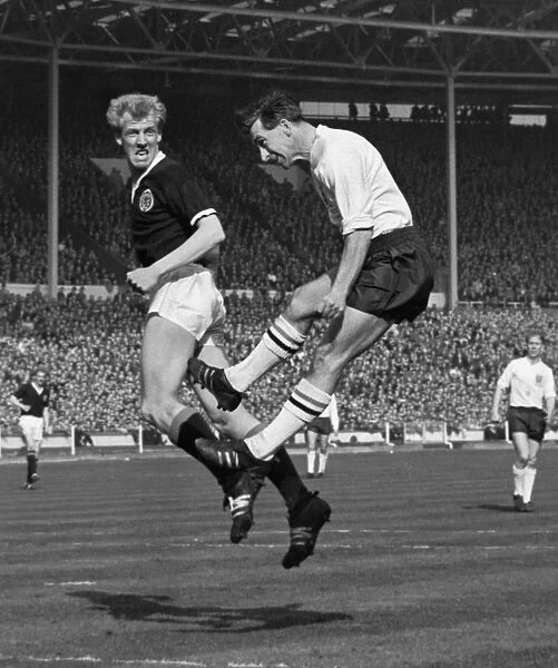 Scotlands Ian Ure and Englands Bryan Douglas jump for the ball - 1963 British Home Championship