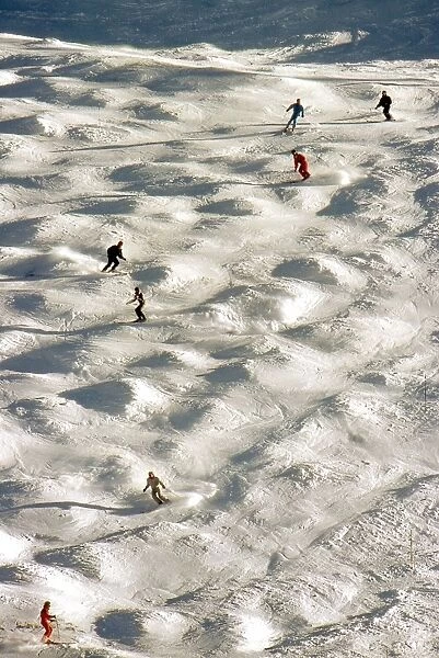 Skiers negotiate a mogul field in Tignes, France in December 1987