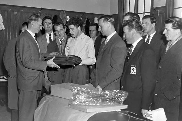 Stanley Matthews is presented with a 43rd birthday present by Aston Villa players