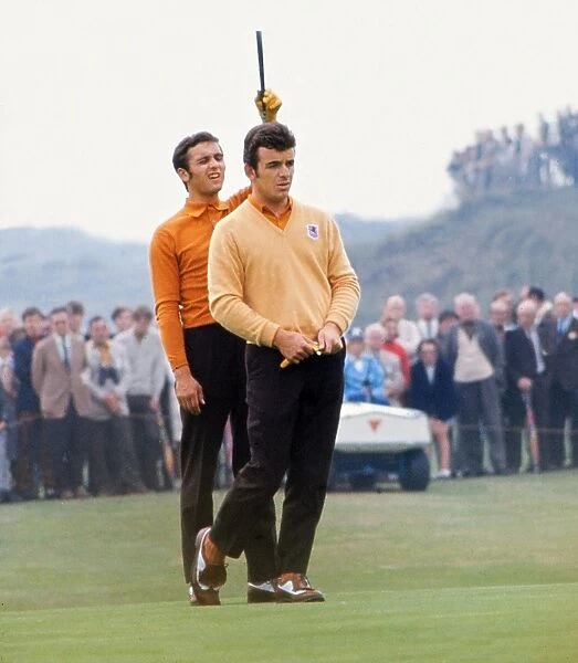 Tony Jacklin and Peter Townsend line up a putt at the 1969 Ryder Cup