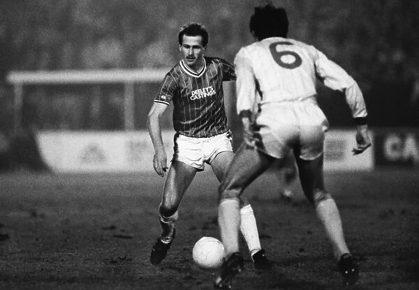 Walsalls Richard O'Kelly runs at Liverpools Alan Hansen during the 1983 / 4 League Cup semi-final