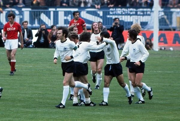 The West German players congratulate Gerd Muller after he opens the scoring the in Euro 72 final