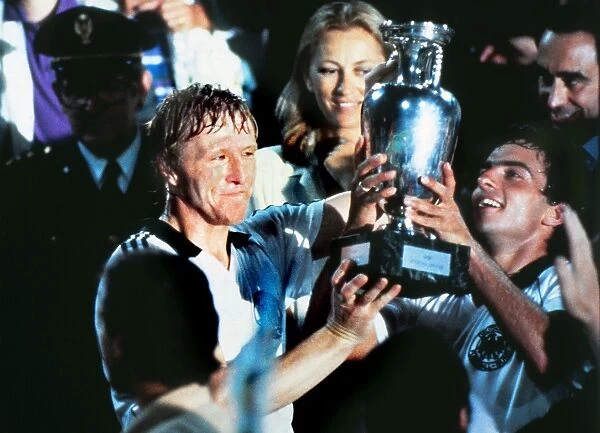 West Germanys Horst Hrubesch and Hans Mueller lift the trophy at Euro 1980