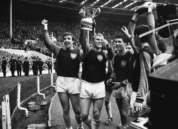 West Ham players Ken Brown, Bobby Moore and Peter Brabrook parade the FA Cup after victory in 1964