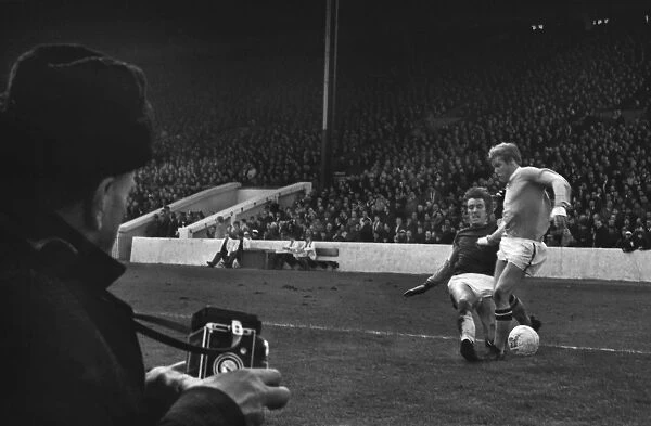 West Hams Billy Bonds tackles Manchester Citys Tony Coleman as a photographer looks on