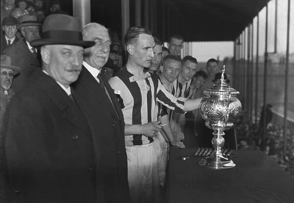 William Cuff presents WBA reserve captain Bob Finch with the Central League trophy in 1933