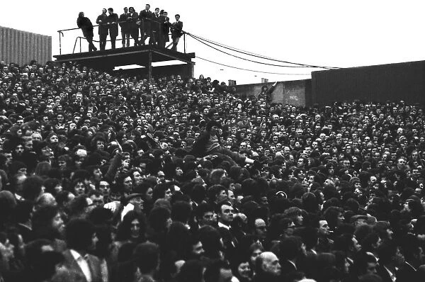 A young fan is passed over the heads of fans in the Clock End at Highbury during the 1973 FA Cup