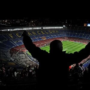 An Arsenal fan sings and dances in the top tier of the Nou Camp before the game against Barcelona