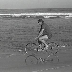 British Lions captain Willie John McBride cycles along the Port Elizabeth beach the day after winning the Test series in South Africa