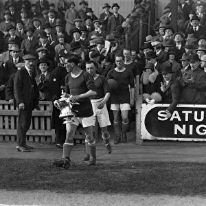 Cardiff City captain Fred Keenor leads his side onto the field with the FA Cup in 1927
