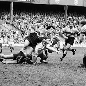 John Jeffrey of the Five Nations is tackled by the Overseas Unions Steve Cutler in 1986
