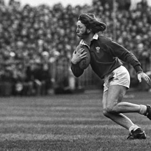 JPR Williams runs with the ball during the 1976 Five Nations