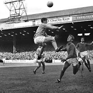 Mike Doyle jumps for a header in the 1967 / 8 Manchester derby at Maine Road