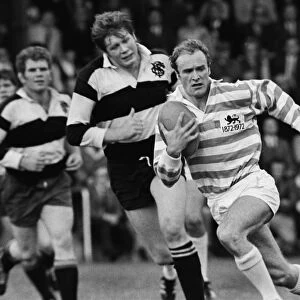 Mike Gibson runs with the ball for a Cambridge University Past and Present side in 1972