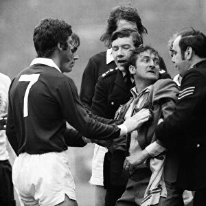 A Scottish fan is removed from the Wembley pitch after attacking Alan Ball - 1973 British Home Championship