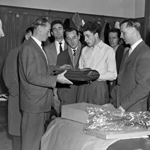 Stanley Matthews is presented with a 43rd birthday present by Aston Villa players