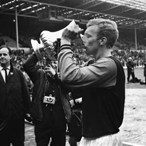 West Ham captain Bobby Moore drinks out of the FA Cup after victory in 1964