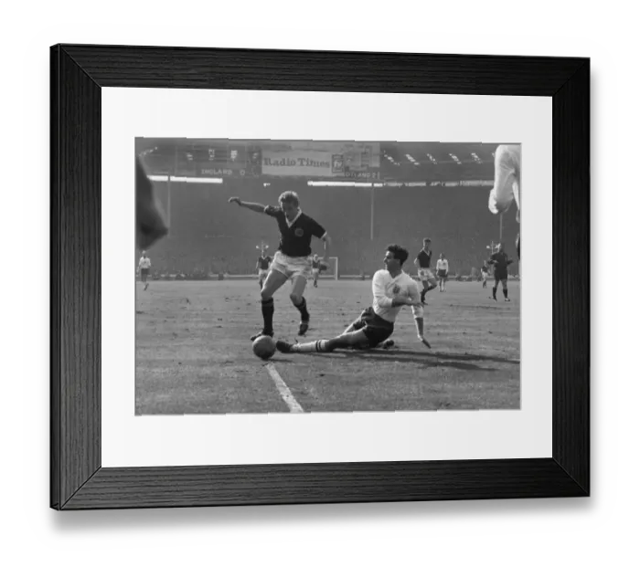Framed Print : Scotlands Denis Law evades Englands Maurice Norman at Wembley in 1963 Framed Print : Scotlands Denis Law evades Englands Maurice Norman at Wembley in 1963