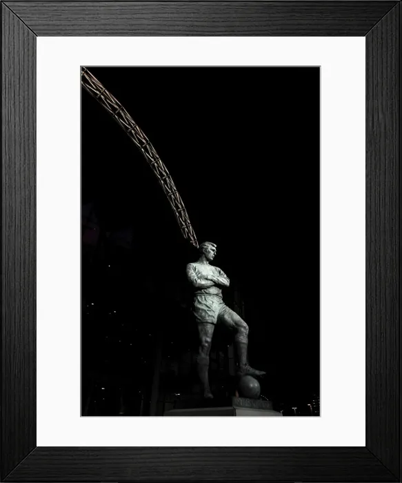 Framed Print : The Bobby Moore statue stands in front of an illuminated Wembley Stadium Framed Print : The Bobby Moore statue stands in front of an illuminated Wembley Stadium