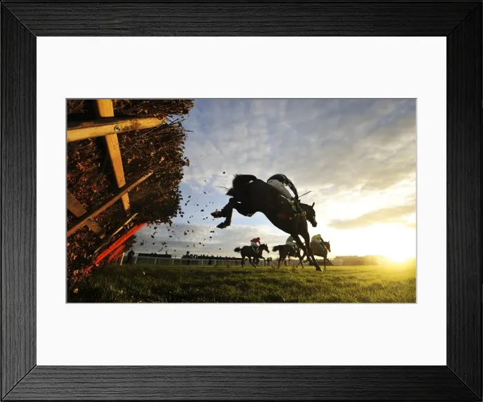 Framed Print : The riders clear the last hurdle of the 15: 05 Stan James International Hurdle at Cheltenham racecourse