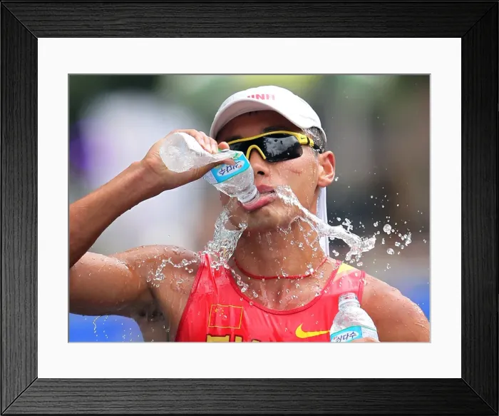 Framed Print : Tianfeng Si takes a drink during the 50km walk at the 2011 World Championship Framed Print : Tianfeng Si takes a drink during the 50km walk at the 2011 World Championship