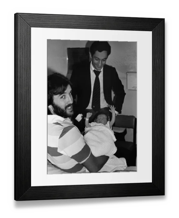 Framed Print : Ricky Villa holds his new baby, as Tottenham team mate Ossie Ardiles comes to visit the child at Chase Farm Hospital, Enfield Framed Print : Ricky Villa holds his new baby, as Tottenham team mate Ossie Ardiles comes to visit the child at Chase Farm Hospital, Enfield