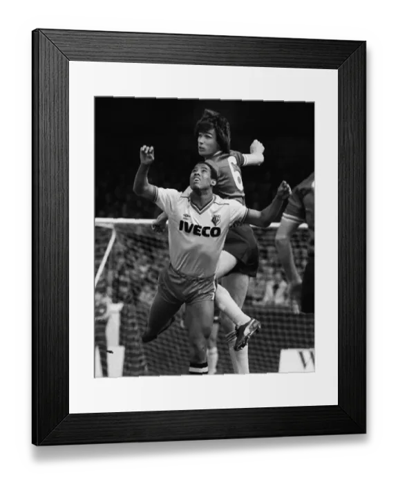 Framed Print : Liverpools Alan Hansen leaps above Watfords John Barnes