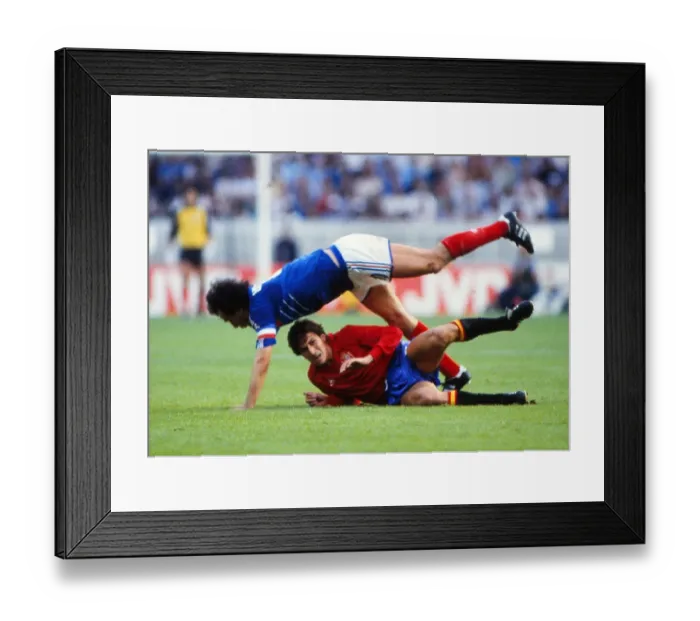 Framed Print : Frances Michel Platini is tackled by Spains Victor Munoz in the final of Euro 84 Framed Print : Frances Michel Platini is tackled by Spains Victor Munoz in the final of Euro 84