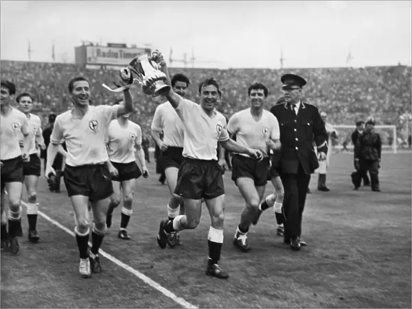 Cliff Jones and Jimmy Greaves parade the FA Cup around Wembley after Spurs victory in 1962