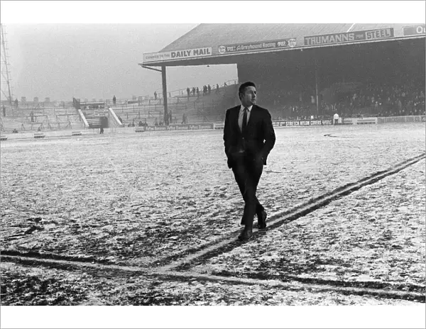 Spurs captain Dave Mackay inspects a snowy Maine Road