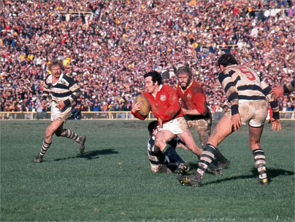 Phil Bennett makes a break for the Lions on the way to scoring a try against Auckland in 1977