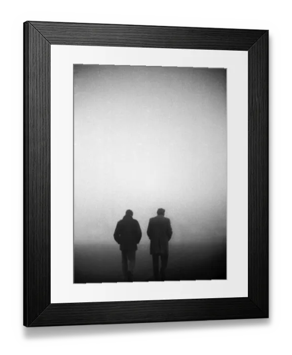 Framed Print : England manager Don Revie and FA Secretary Ted Coker walk off the pitch in the fog after the game against Czechoslovakia is abandoned in 1975