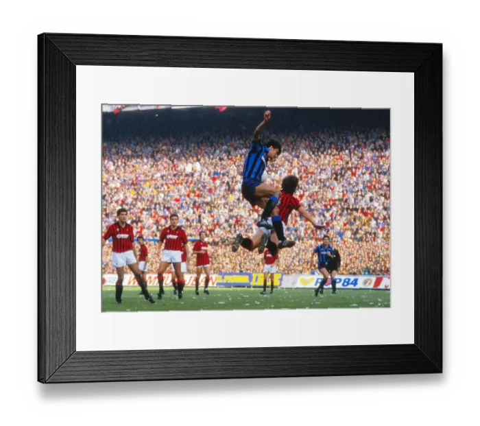 Framed Print : Alessandro Altobelli and Mark Hateley compete in the air during the Milan Derby in 1984