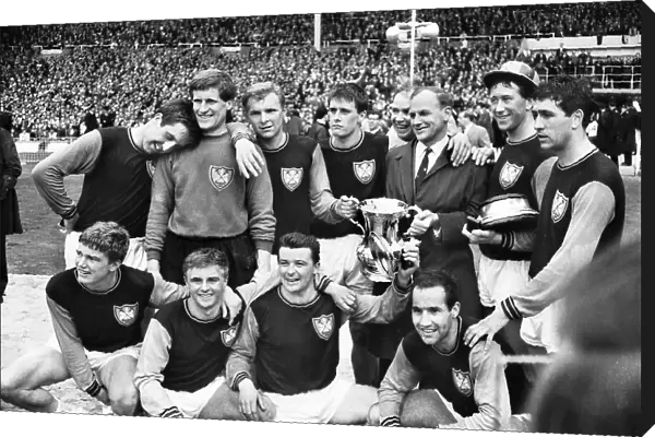 West Ham manager Ron Greenwood celebrates victory with his players after the 1964 FA Cup Final