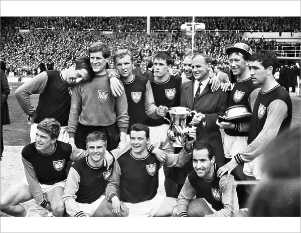 West Ham manager Ron Greenwood celebrates victory with his players after the 1964 FA Cup Final