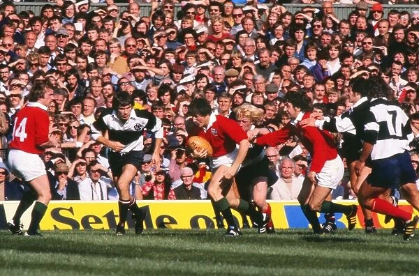 Andy Irvine runs with the ball for the British Lions against the Barbarians in 1977