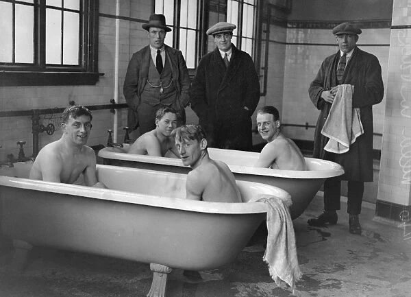 Aston Villa bathe in the changing rooms baths after a training session in 1923  /  4