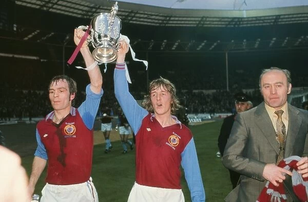 Aston Villas Ian Ross and Ian Chico Hamilton parade the League Cup with manager Ron Saunders in 1975