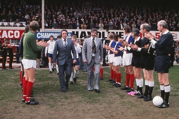 Dave Mackay and Des Anderson are applauded onto the field as they lead out their title-winning Derby County side at the Baseball Ground in 1975
