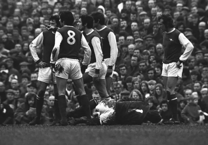 Framed Print : Frank McLintock points the finger at an Ipswich player as Bob Wilson lies injured Framed Print : Frank McLintock points the finger at an Ipswich player as Bob Wilson lies injured