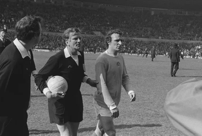Framed Print : Manchester Citys Mike Summerbee is escorted off the pitch after Manchester United fans invade the field in 1974 Framed Print : Manchester Citys Mike Summerbee is escorted off the pitch after Manchester United fans invade the field in 1974