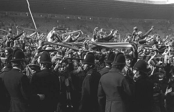 Manchester United fans invade the Old Trafford pitch after Denis Laws goal for Manchester City in 1974