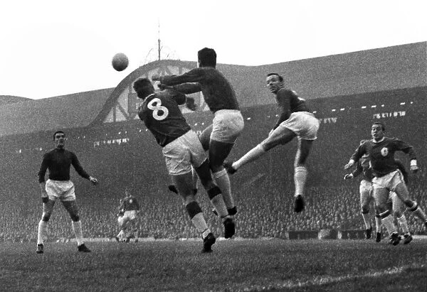 Manchester United goalkeeper Patrick Dunne punches the ball clear at Anfield in 1964  /  5
