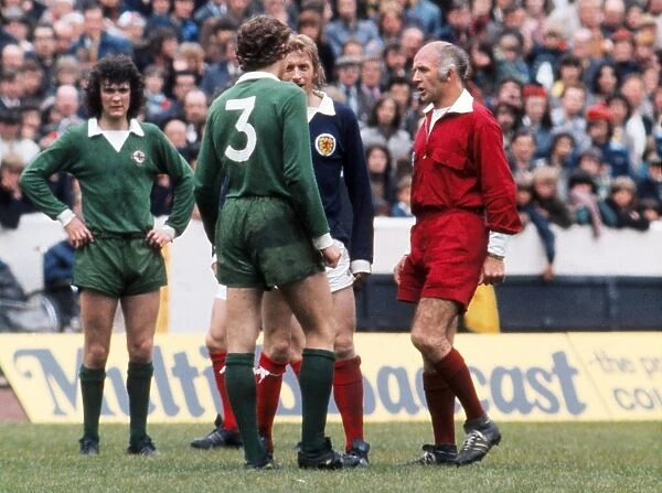 Sammy Nelson and Denis Law square up as referee Iorwerth Jones steps in - 1974 British Home Championship