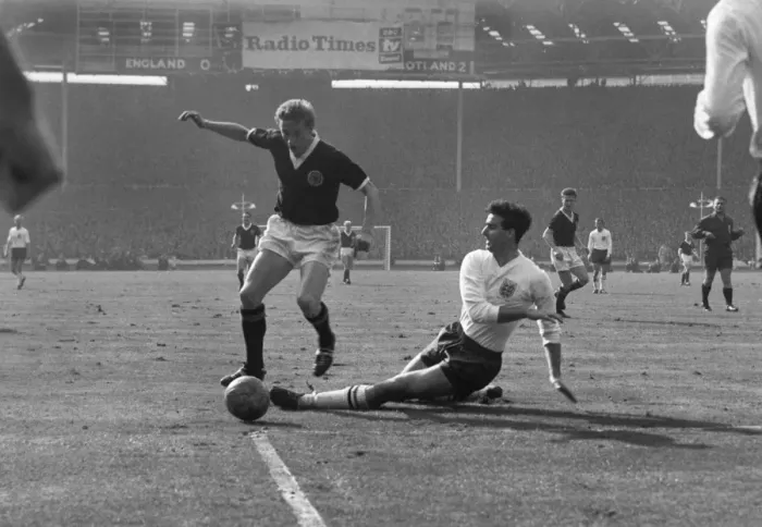 Framed Print : Scotlands Denis Law evades Englands Maurice Norman at Wembley in 1963 Framed Print : Scotlands Denis Law evades Englands Maurice Norman at Wembley in 1963