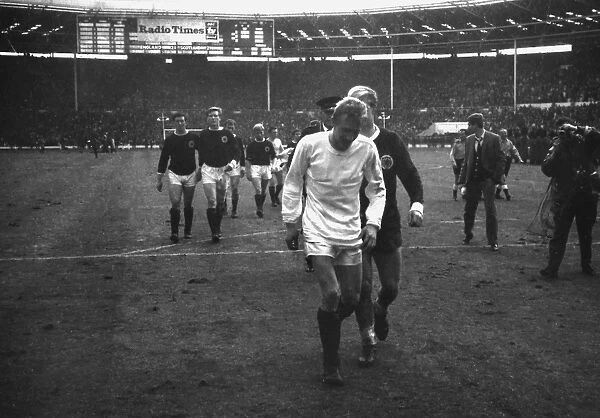 Scotlands Denis Law, wearing Bobby Charltons England shirt, walks off the Wembley pitch in 1965